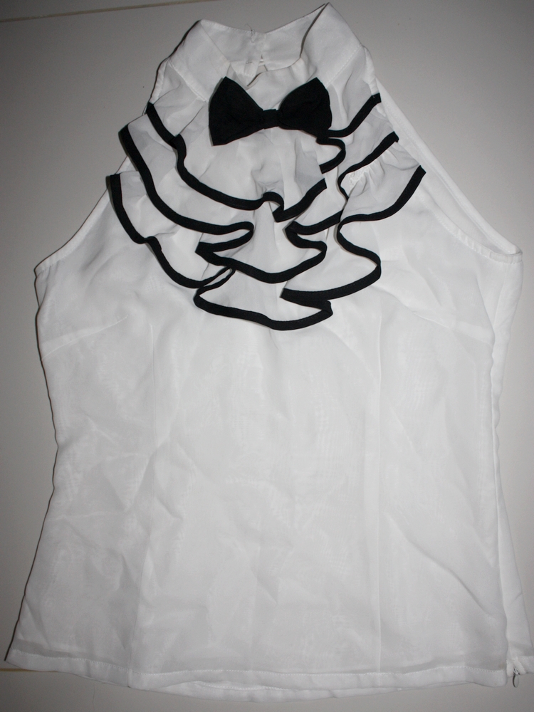 frilled white top with bowtie appliqué